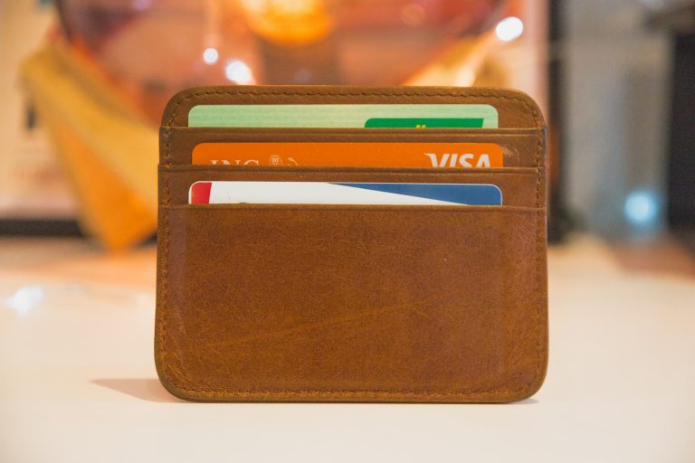 A leather card holder with several bank cards