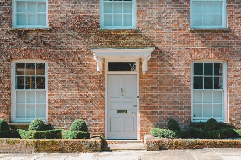 A red-brick house with a pale blue front door