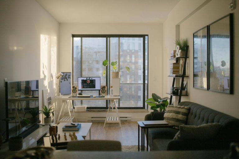 A bright flat with a sofa and a desk by the window